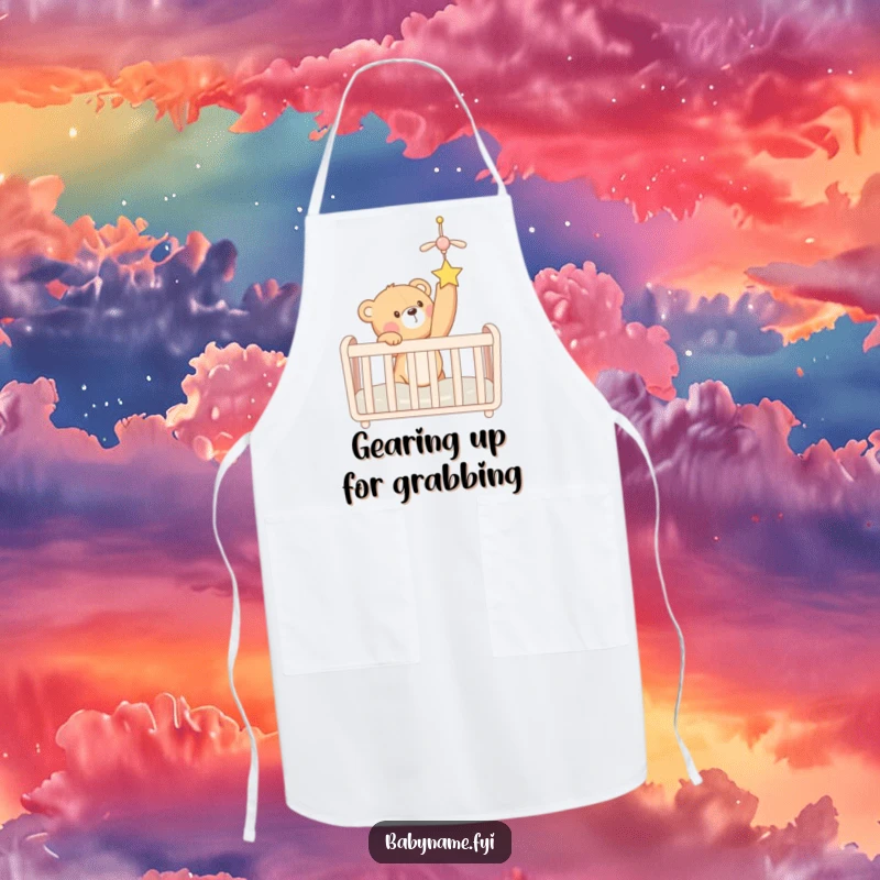 Funny teddy bear in a crib reaching for a mobile, printed on a kitchen apron. A humorous and practical accessory.