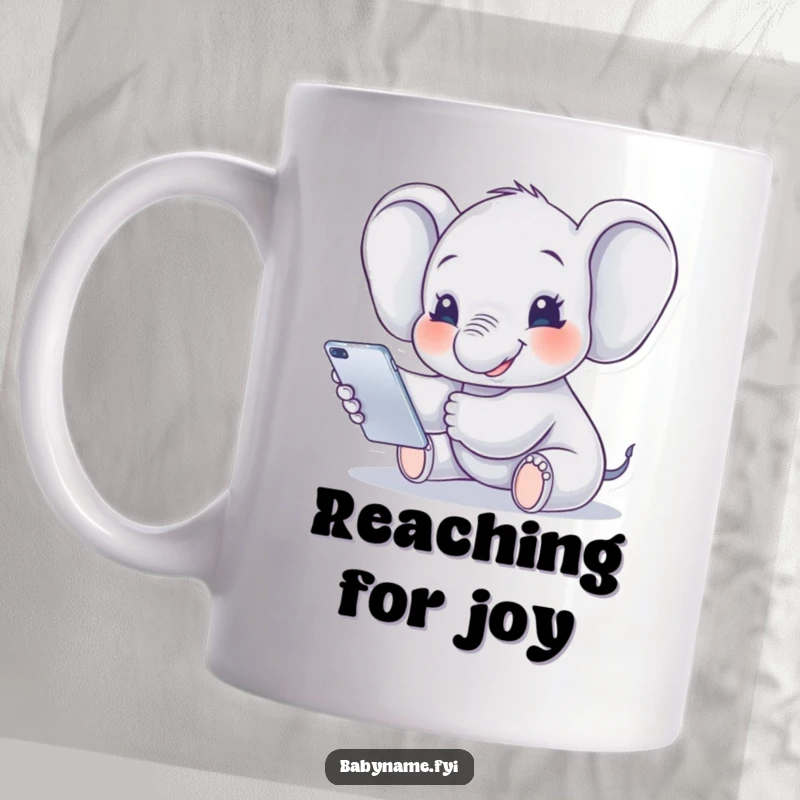 Funny Ceramic Mug featuring a smiling baby elephant reaching playfully for a colorful mobile, radiating joy and innocence.