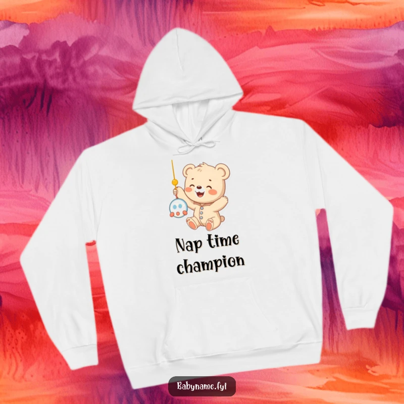 Funny baby bear cub in a cozy onesie, reaching up towards a mobile, radiating pure happiness on a warm and comfortable hoodie.